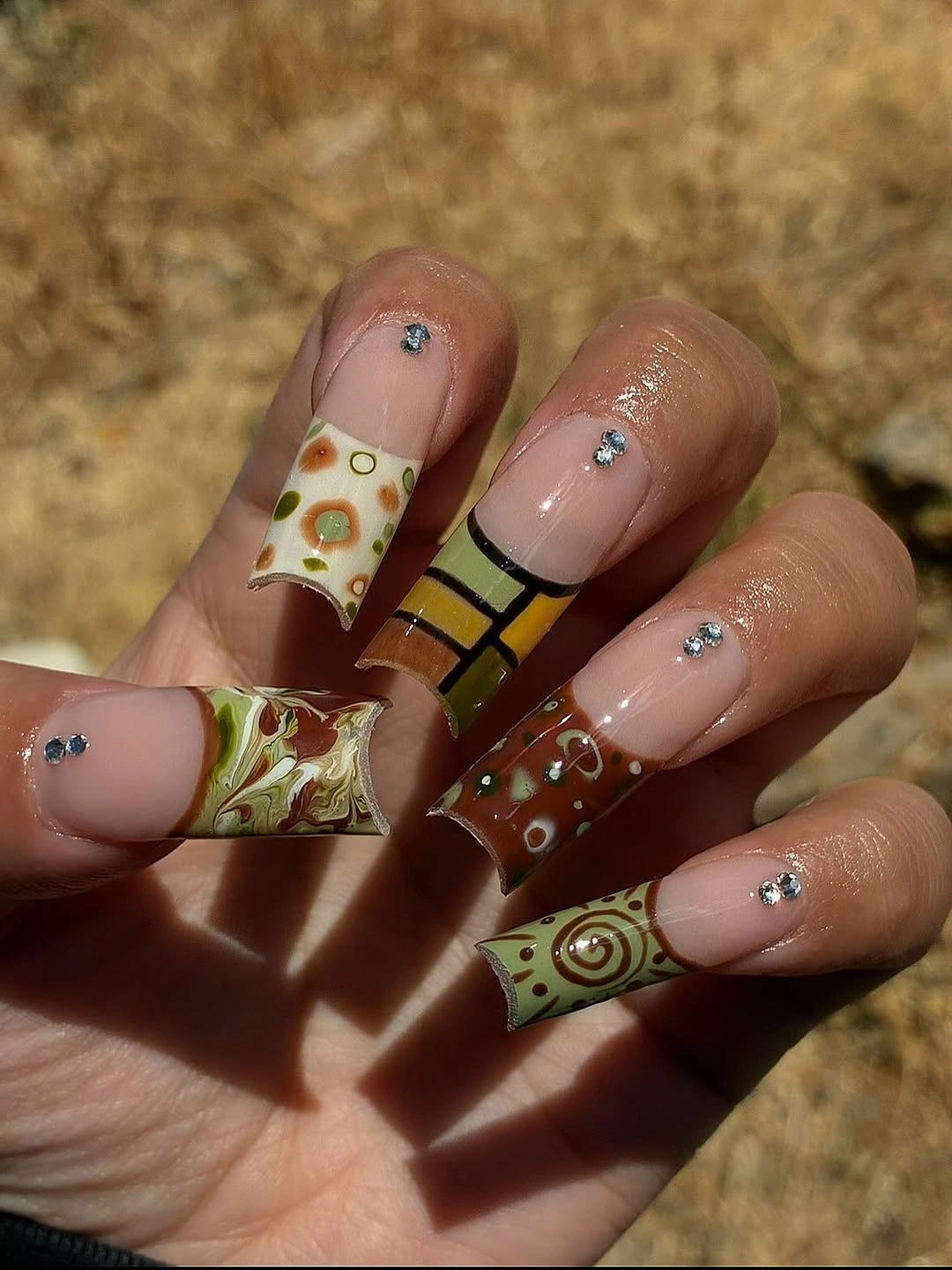 olive mustard square nails with retro swirls and blue accents
