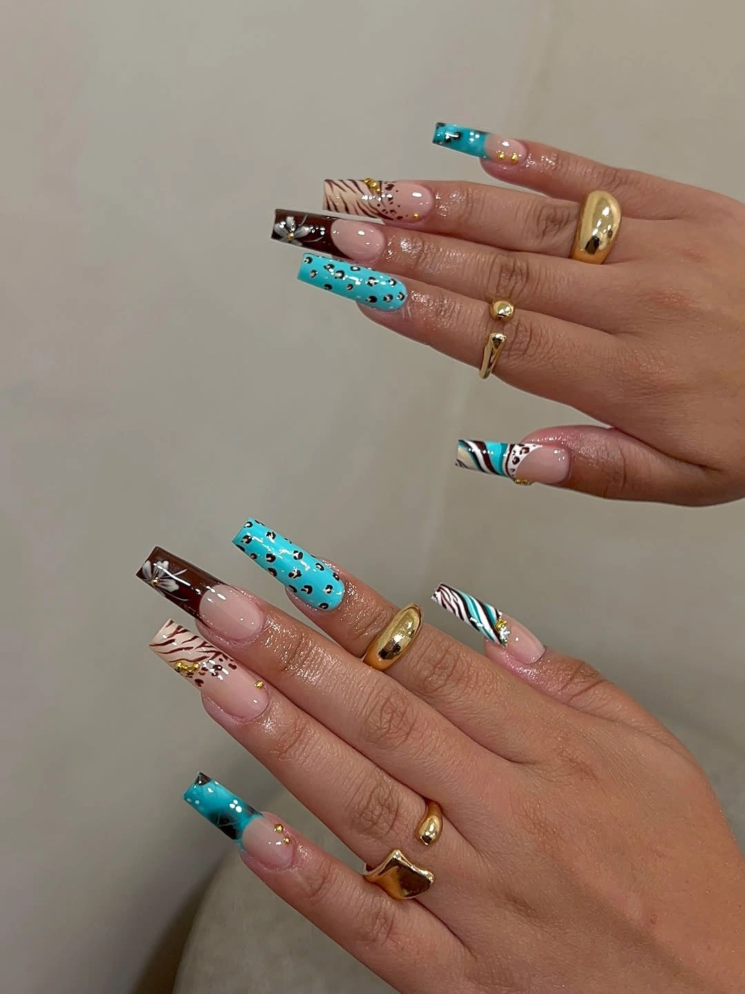 nude square nails with turquoise tips and warm brown accents