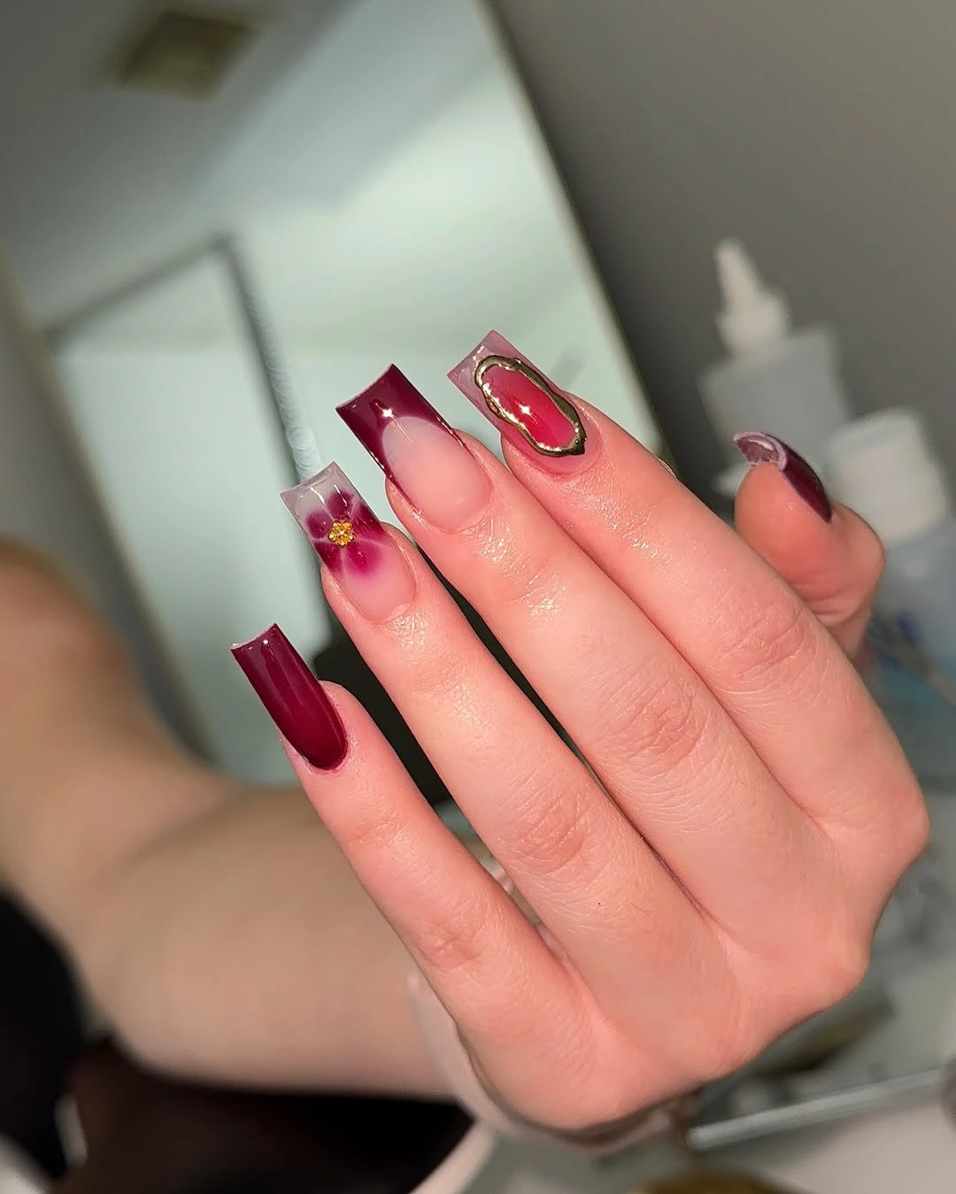 blush pink square nails with burgundy tips and thin gold frames