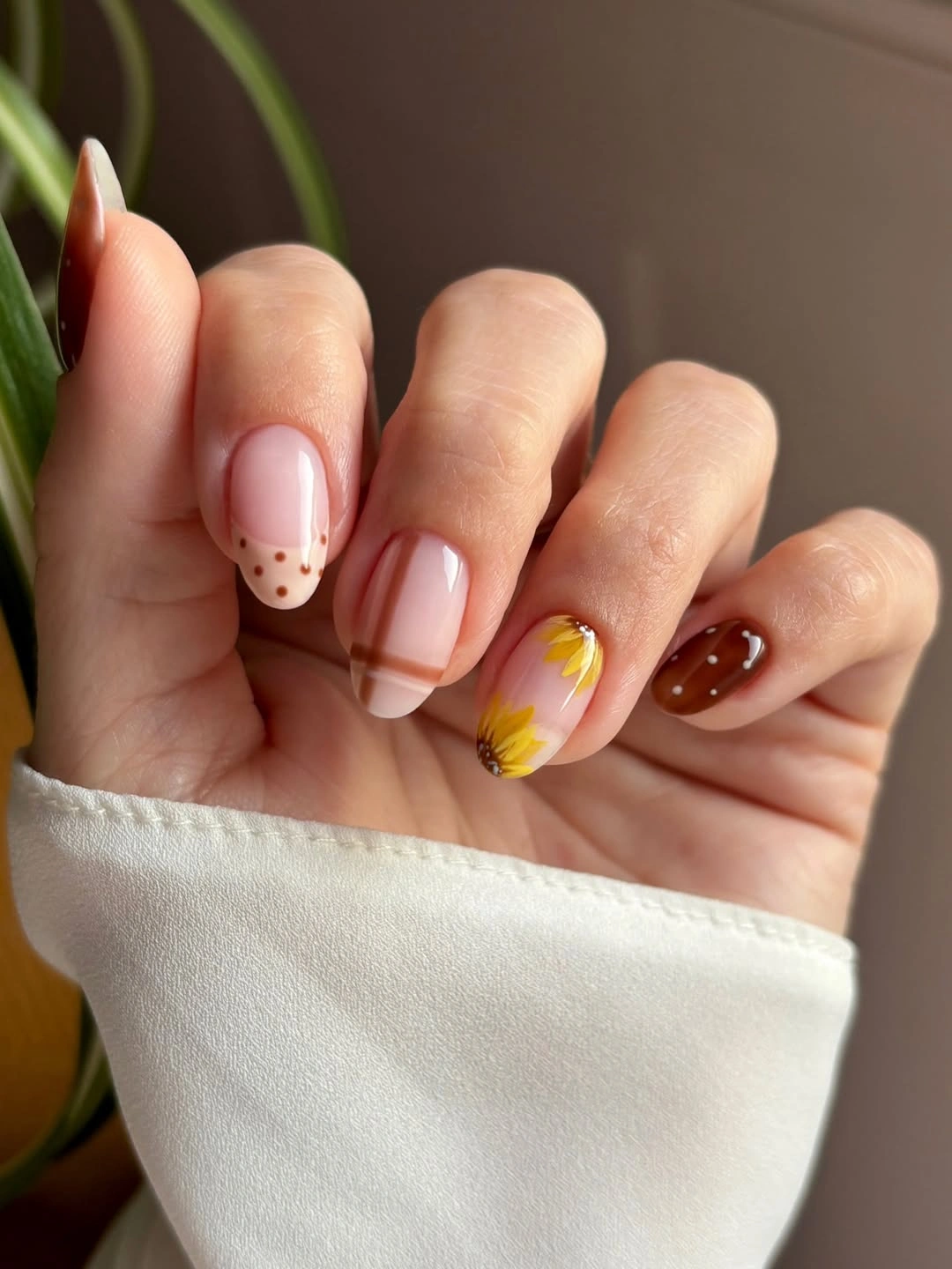 short pink squoval nails with burgundy and dotted accents