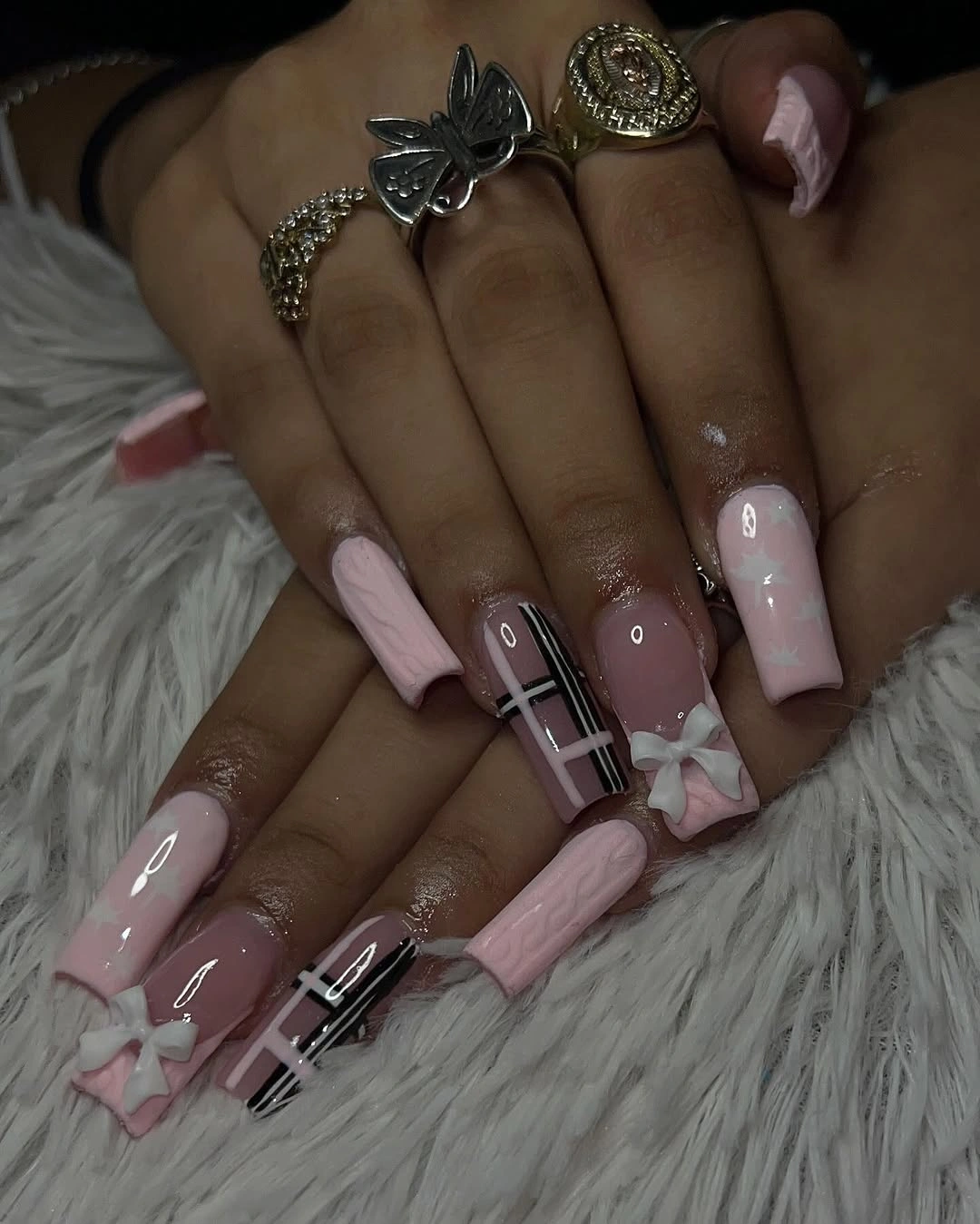 mauve square nails with plaid graphics and bow-like accents