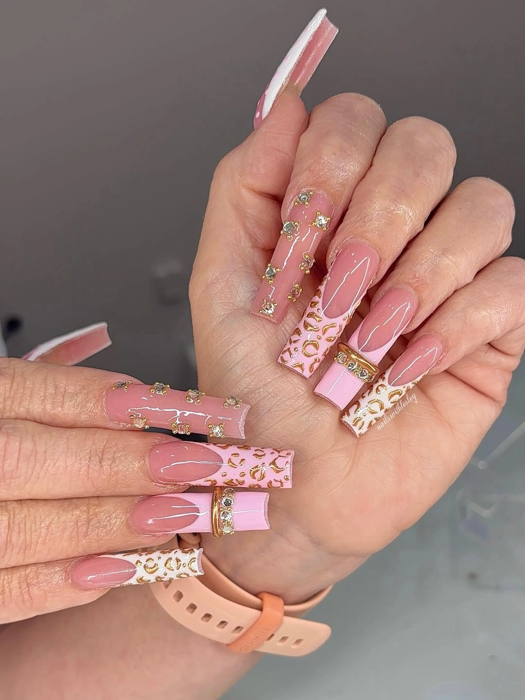 pale pink square nails with spotted panels and fine gold accents