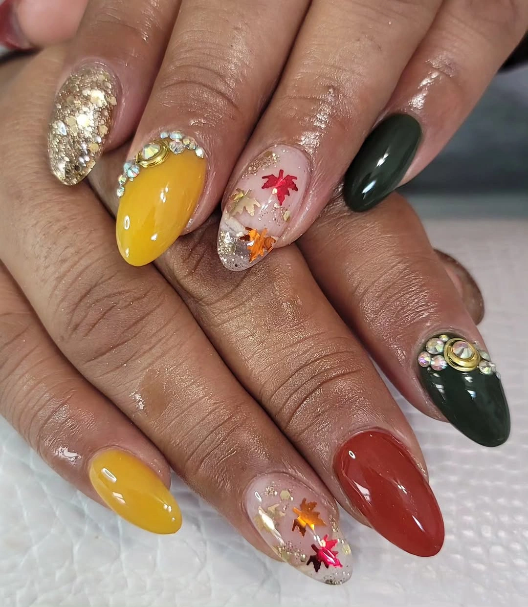 Almond nails in mustard green brown and gold