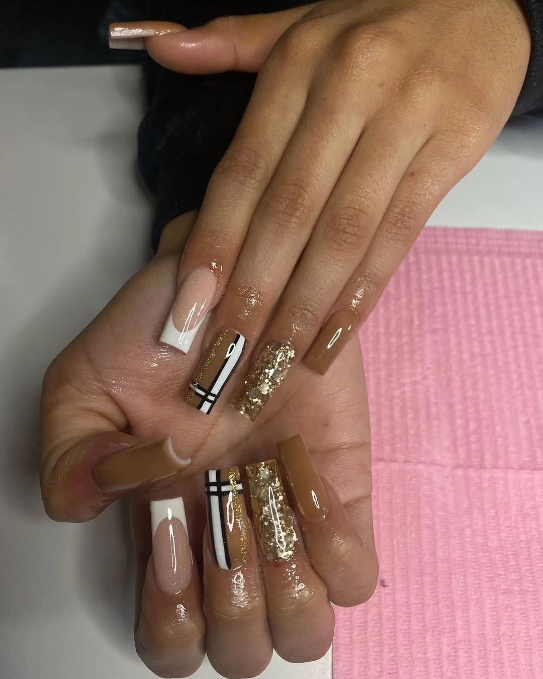 Tan square nails with linework and glitter accents
