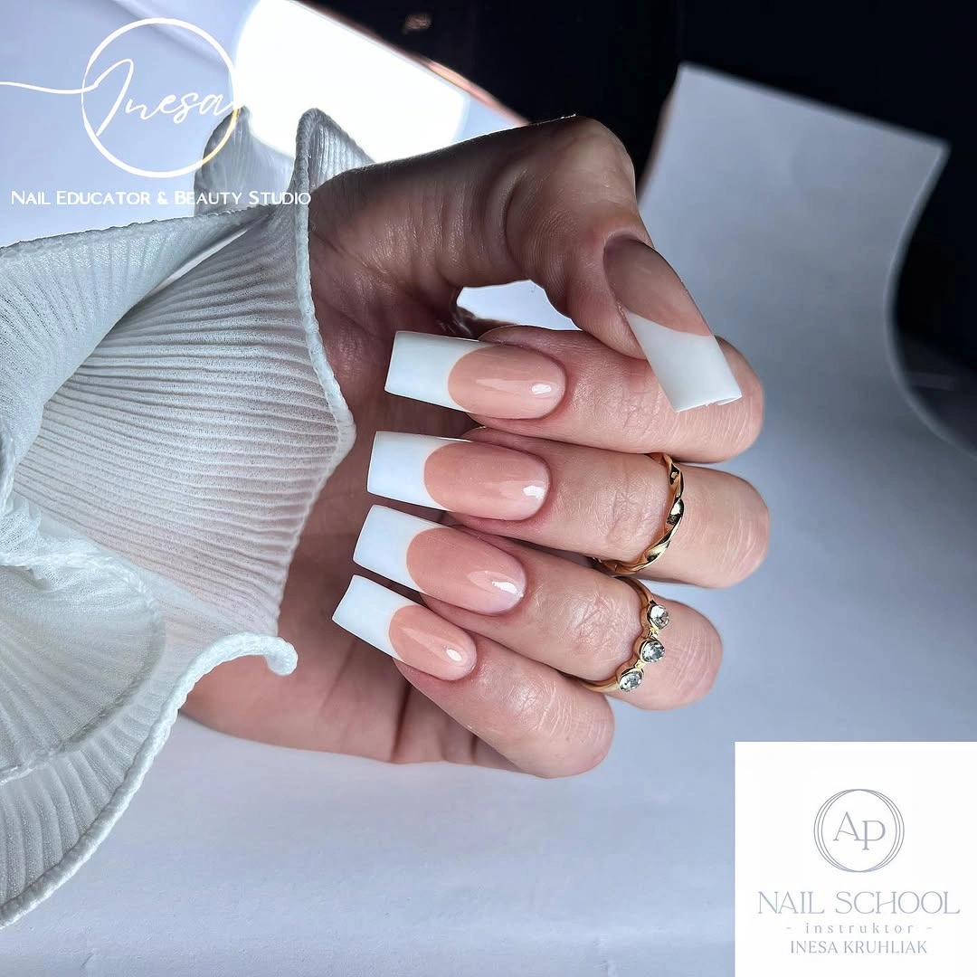 Long square nude nails with wide white French tips
