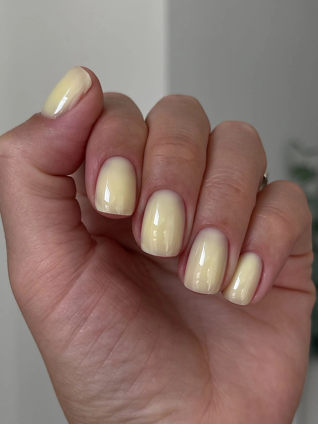 Pale yellow glossy short rounded-square nails