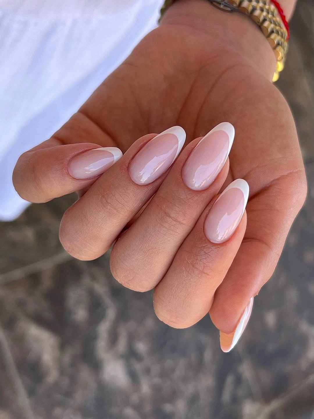 Classic white French tips on sheer almond nails