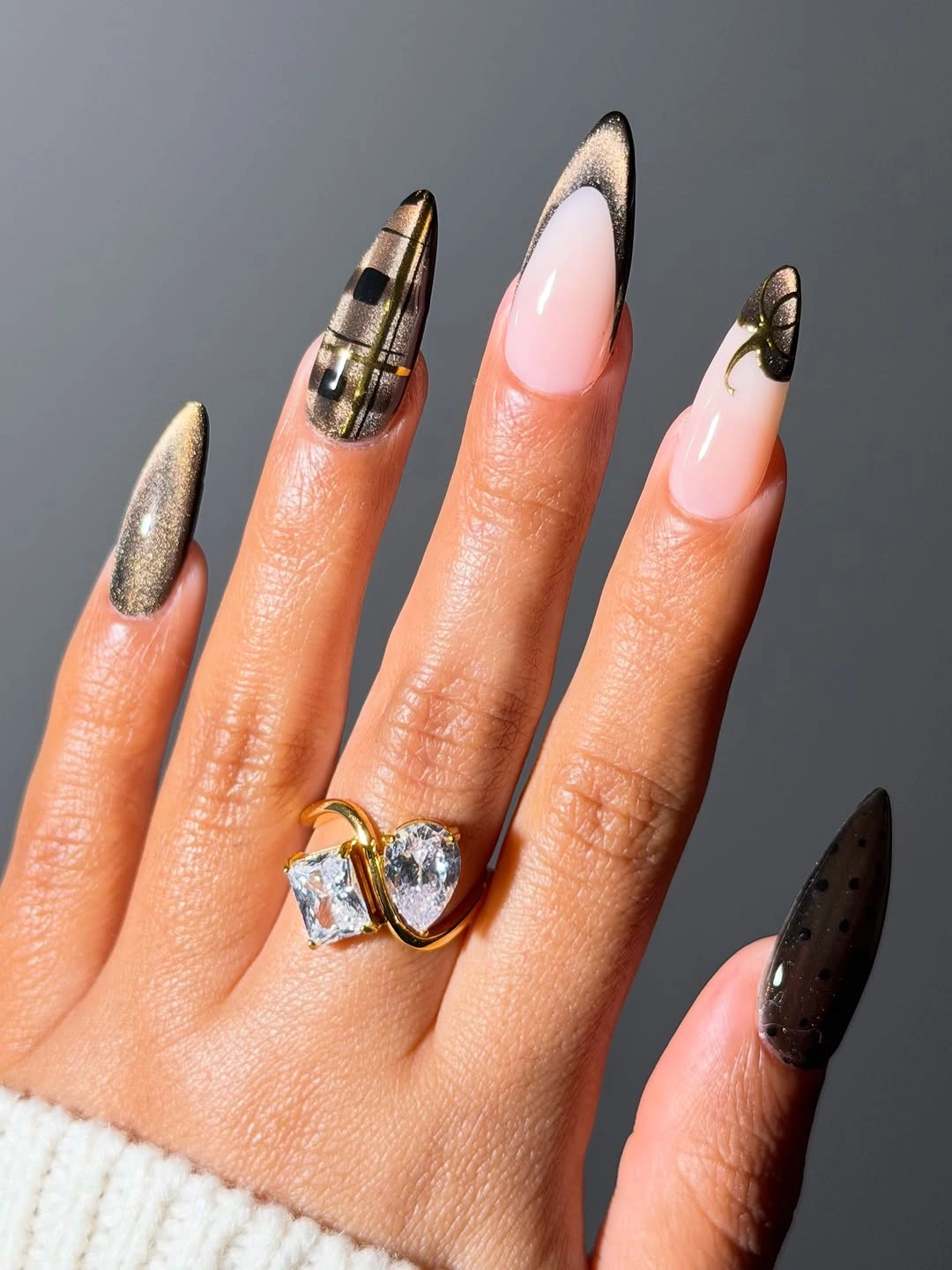 Long almond nails with plaid metallic and black accents