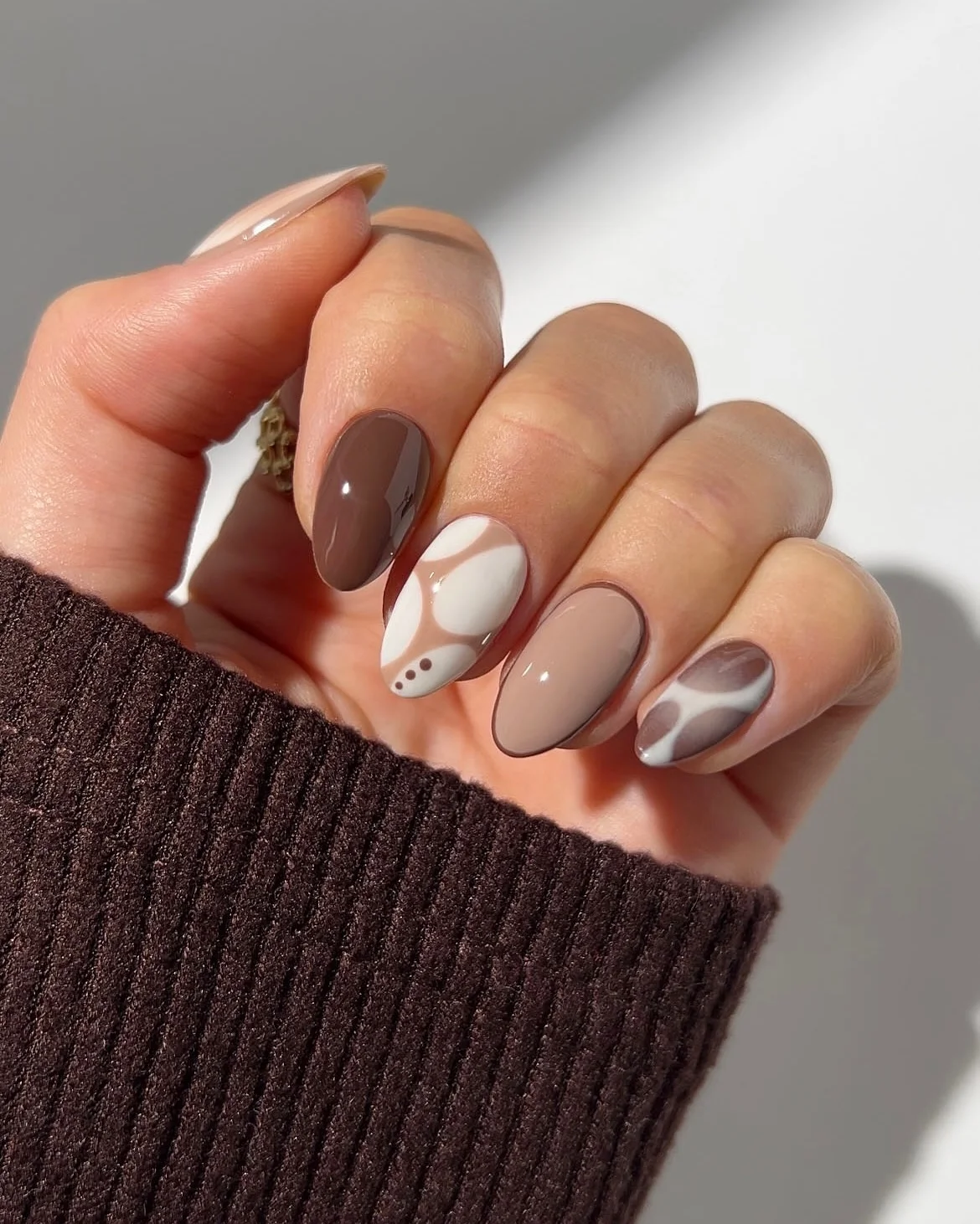 Short almond nails with neutral abstract swirl designs