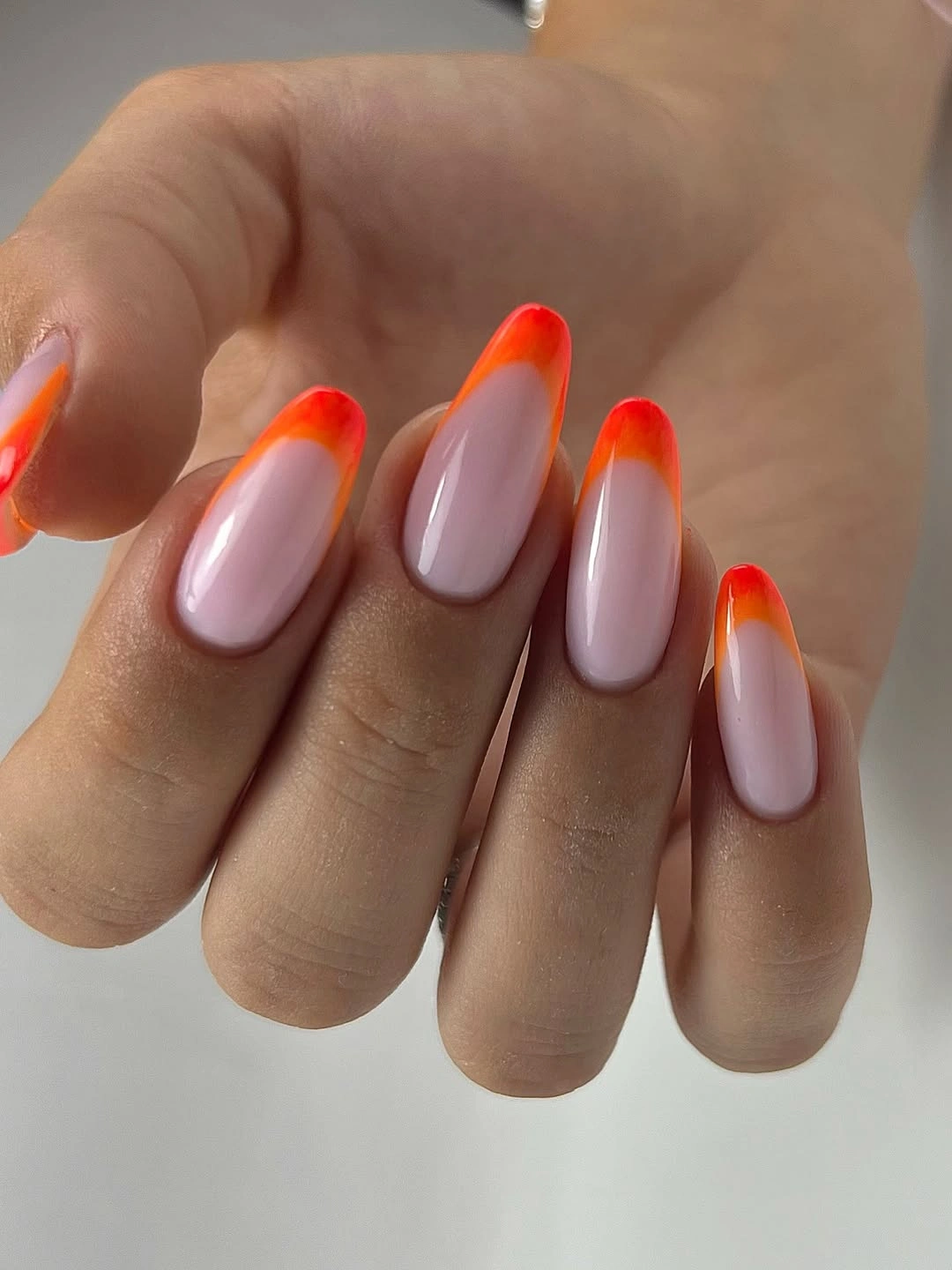 Milky almond nails with orange red gradient tips