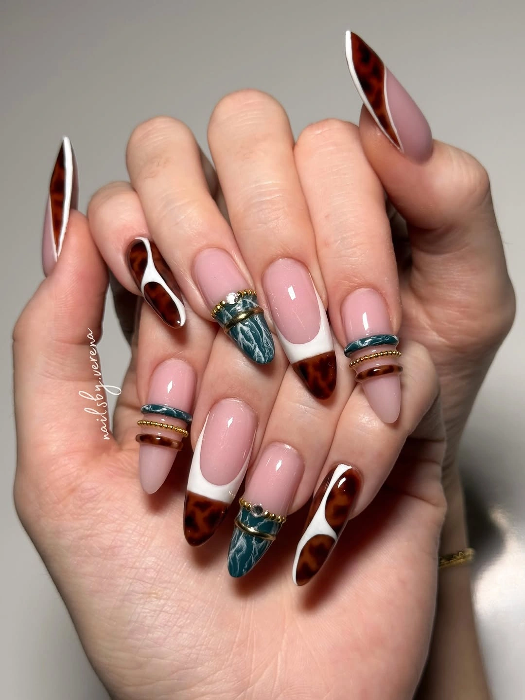 Long almond nails with tortoise teal and gold accents