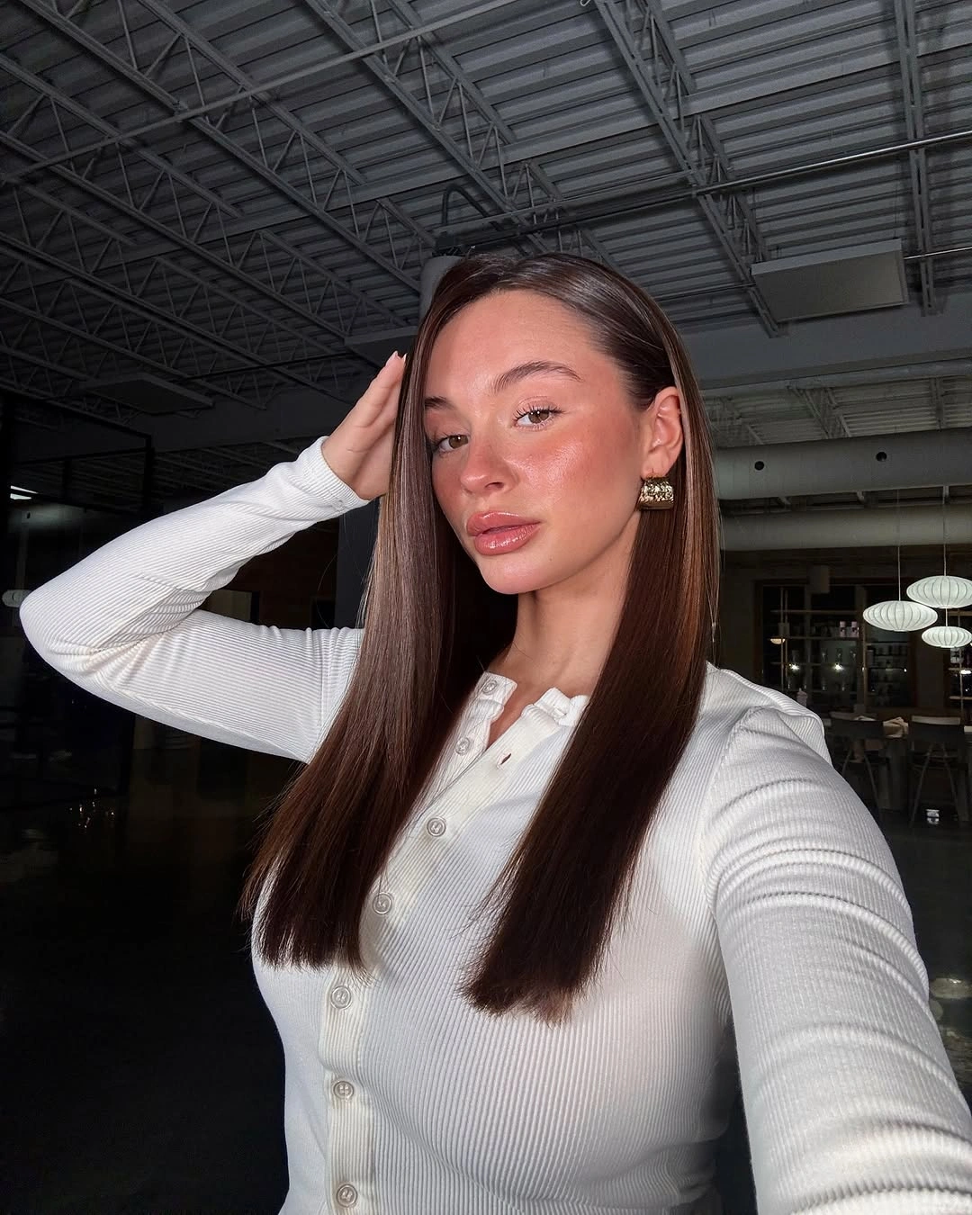 Long straight warm brown hair with understated face layers