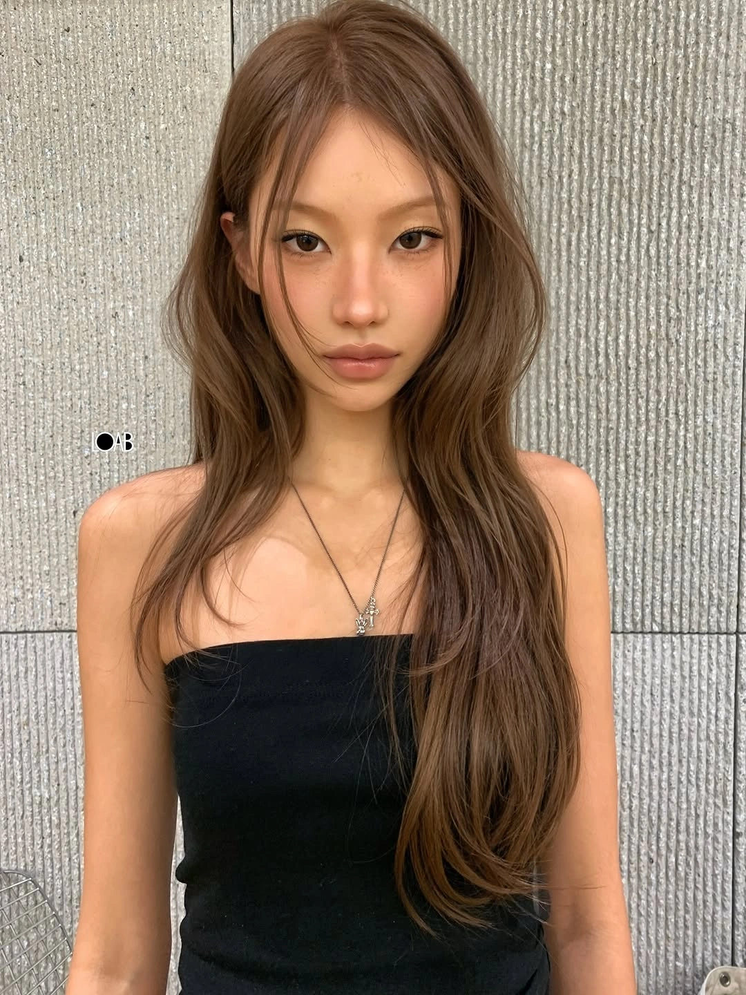 Very long warm brown hair with subtle face framing layers