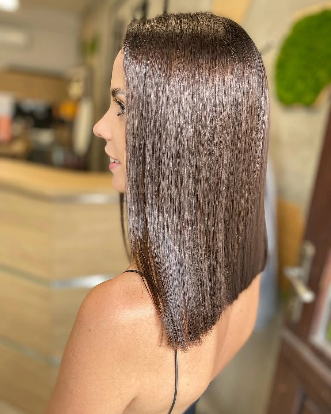 Light chocolate brown hair in a sleek compact cut