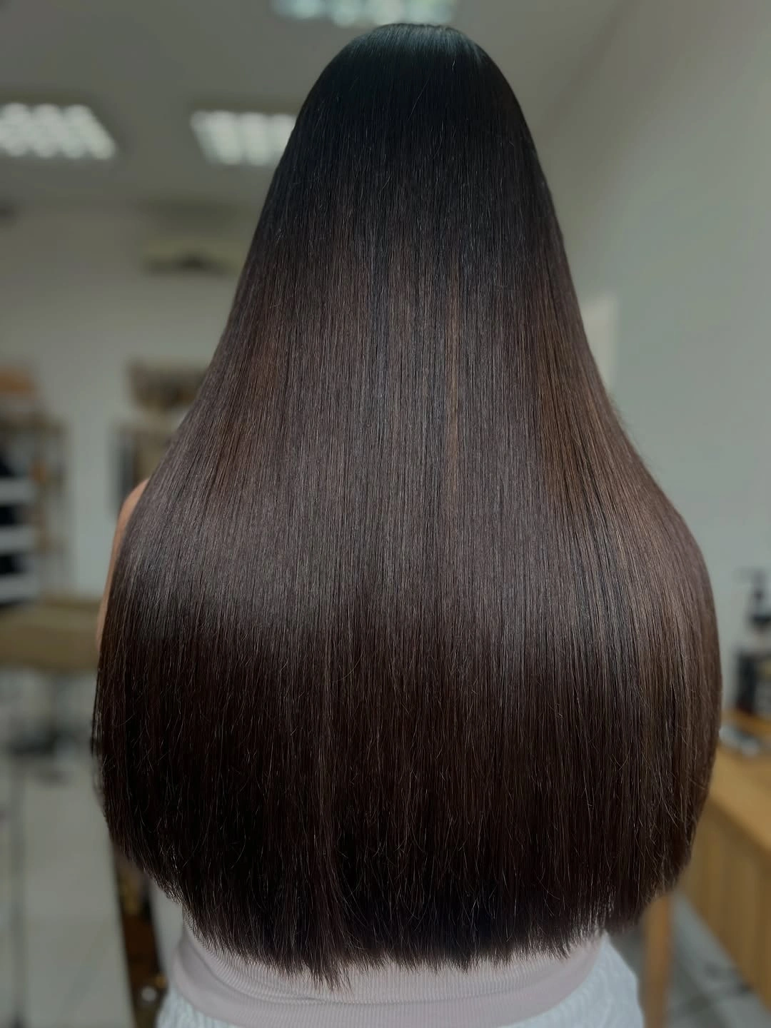 Long dark brown hair with a full straight hemline