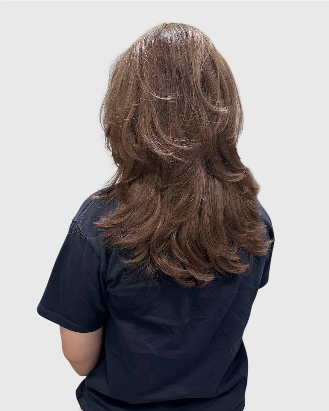 Feathered brown layers with softly flipped outward ends