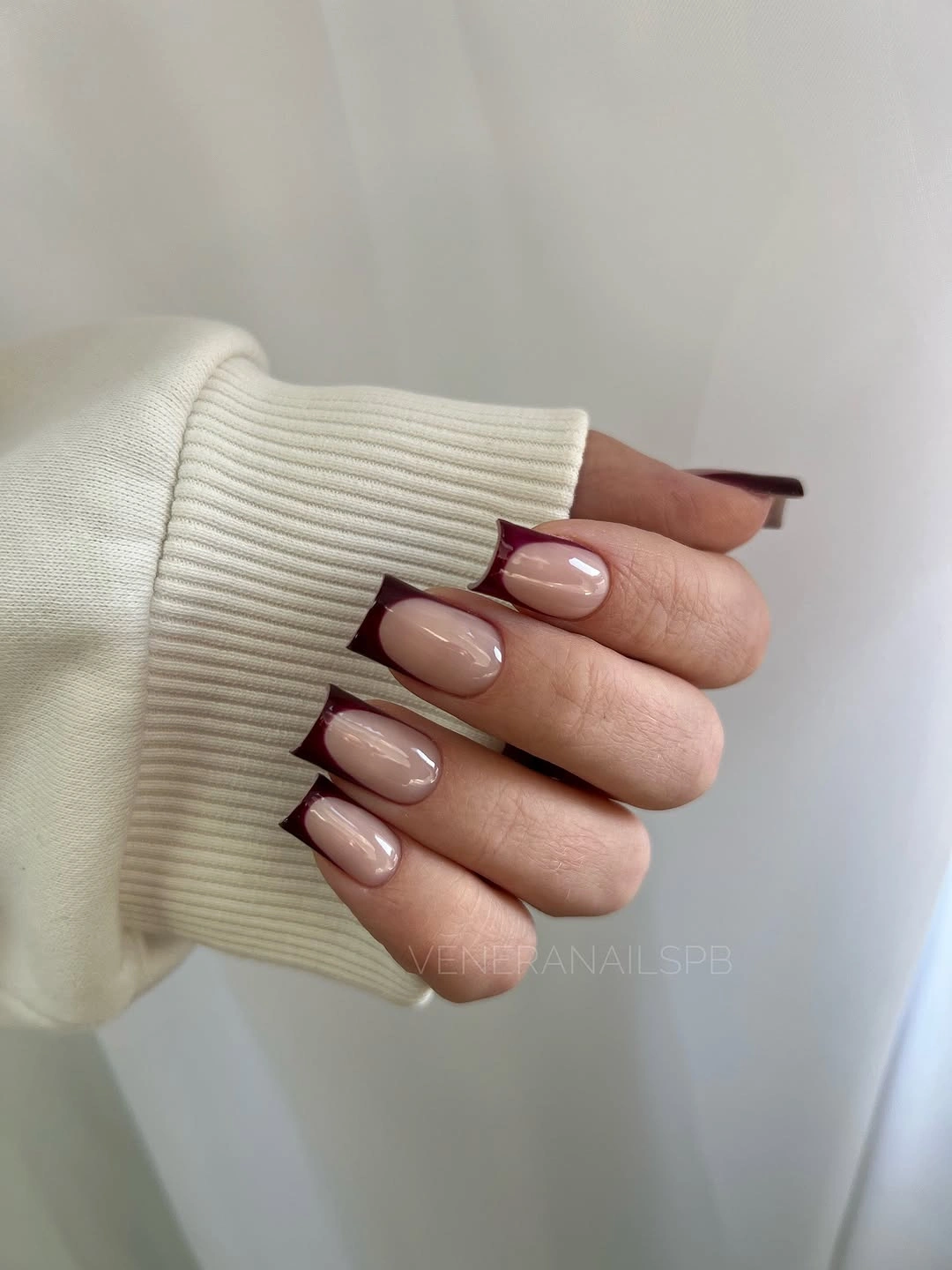 Short rounded nails in soft nude beige with minimal contrast