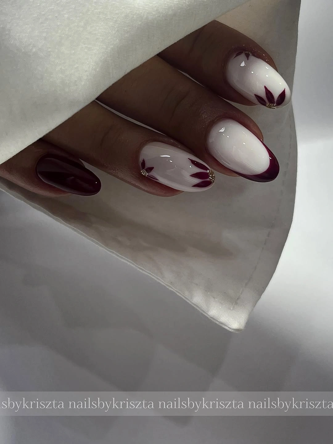 Long almond nails with white nude and burgundy flowers