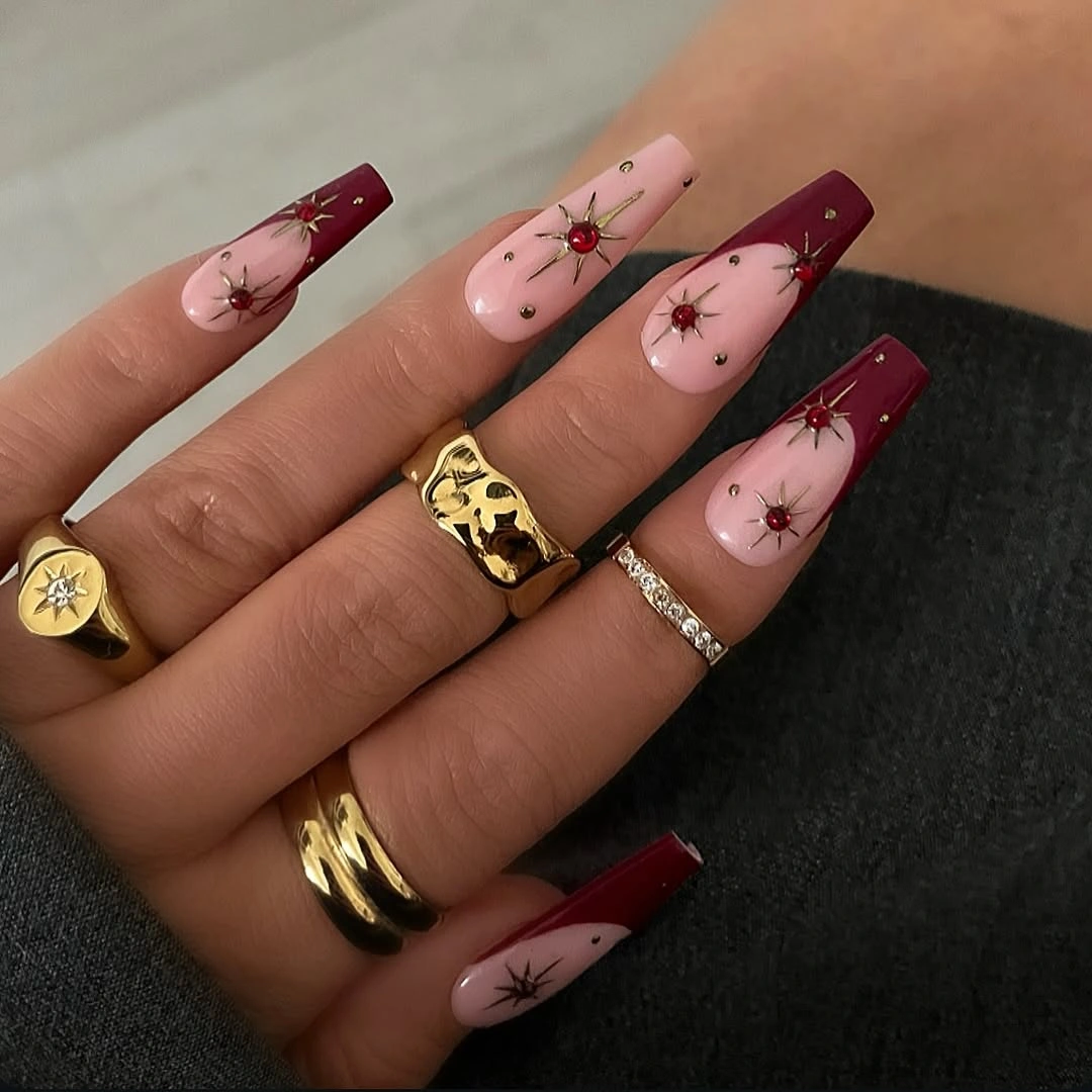 Long coffin nails with burgundy tips and floral accents