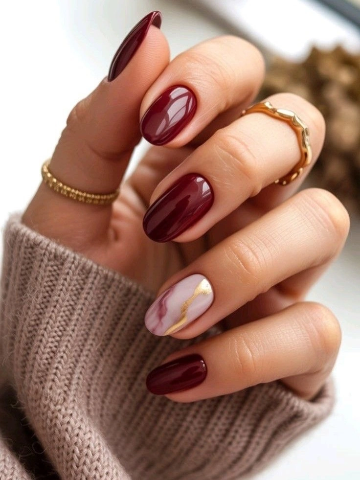 Medium almond burgundy nails with pale marbled accent