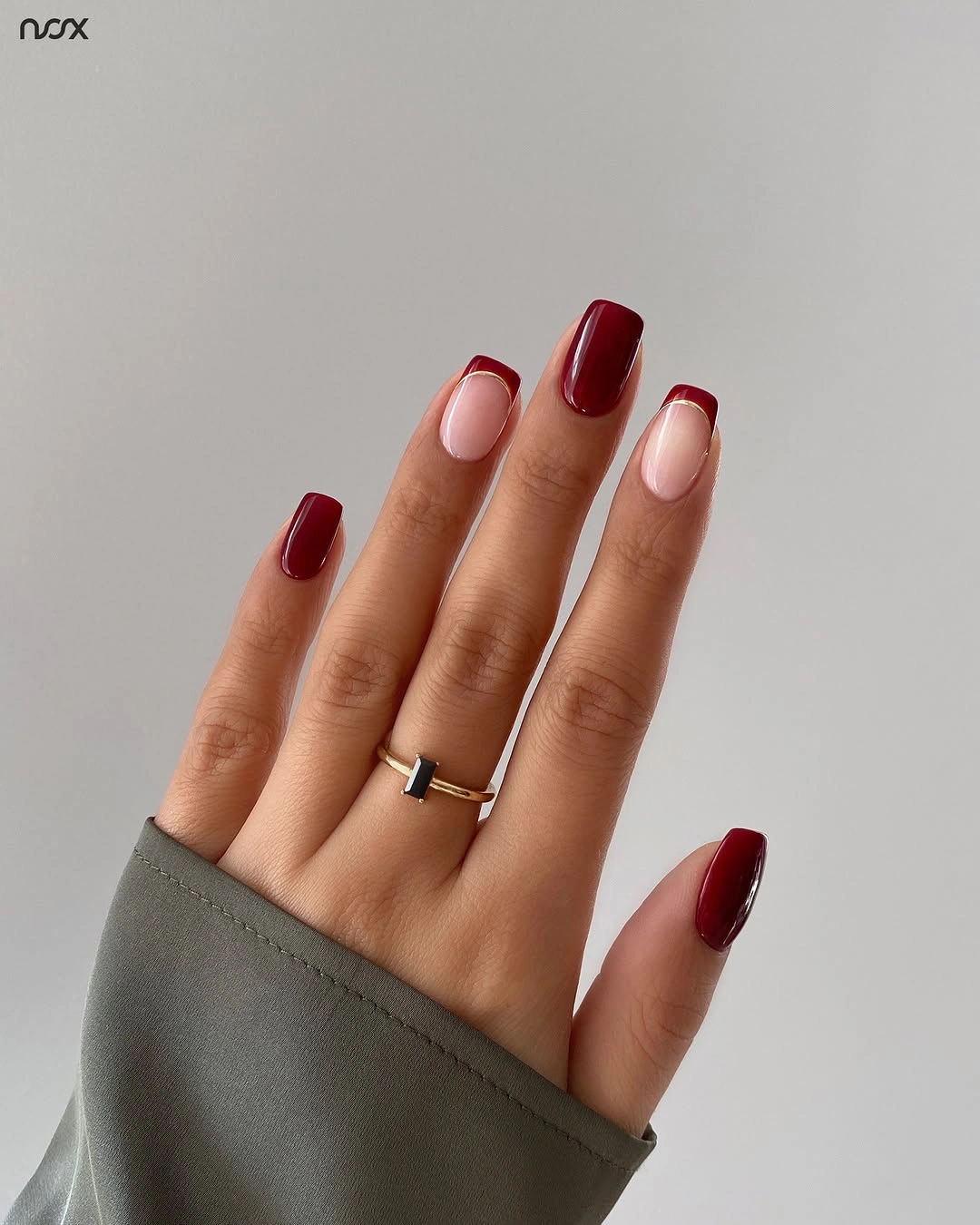 Medium almond nails in a clean deep red burgundy shade