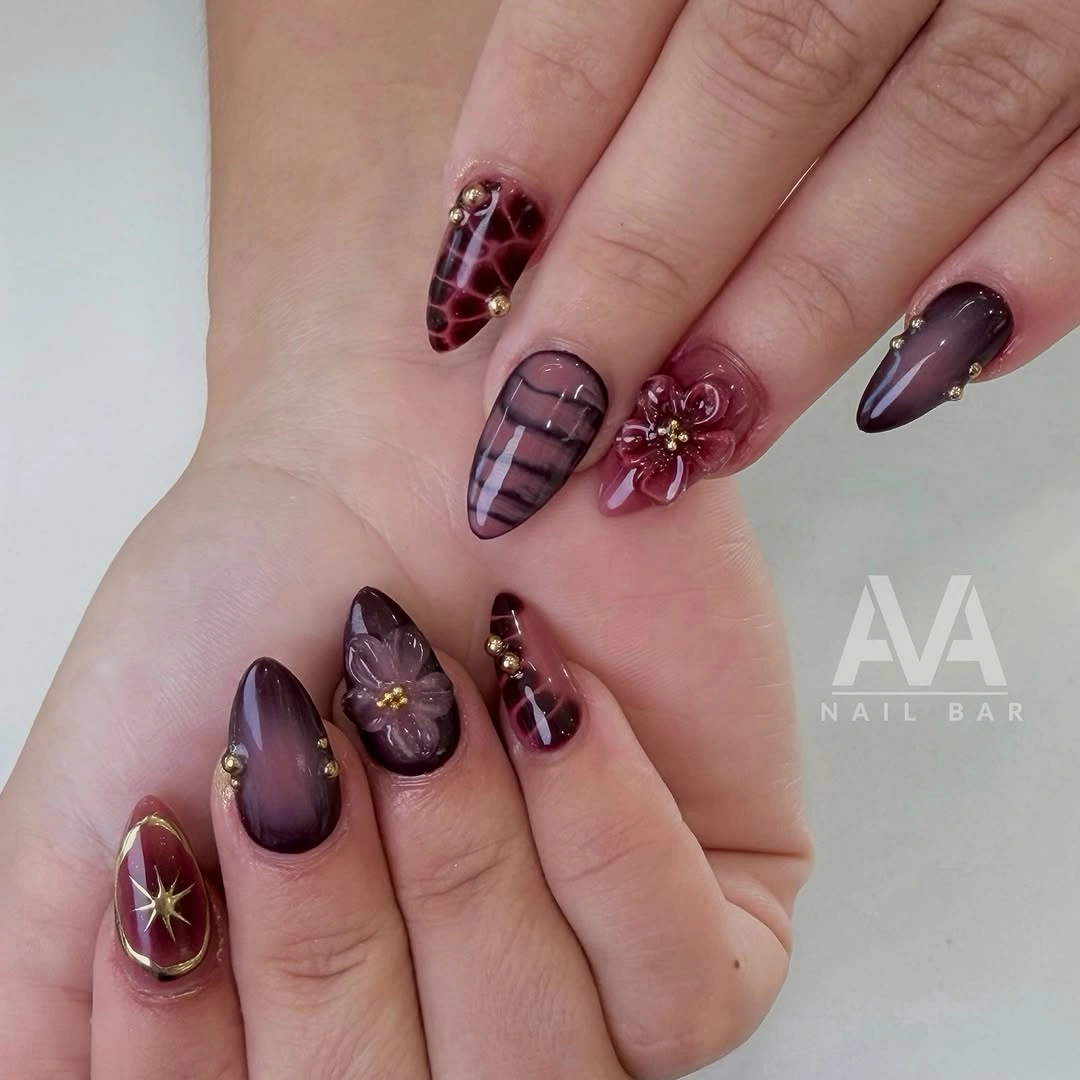 Medium plum burgundy nails with fine floral grid details