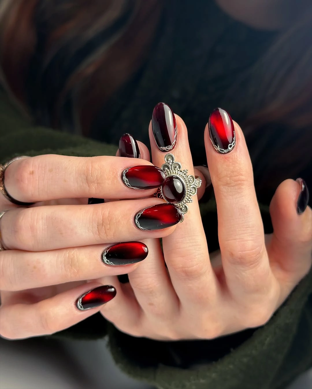 Medium almond red black gradient nails with silver and jeweled accents