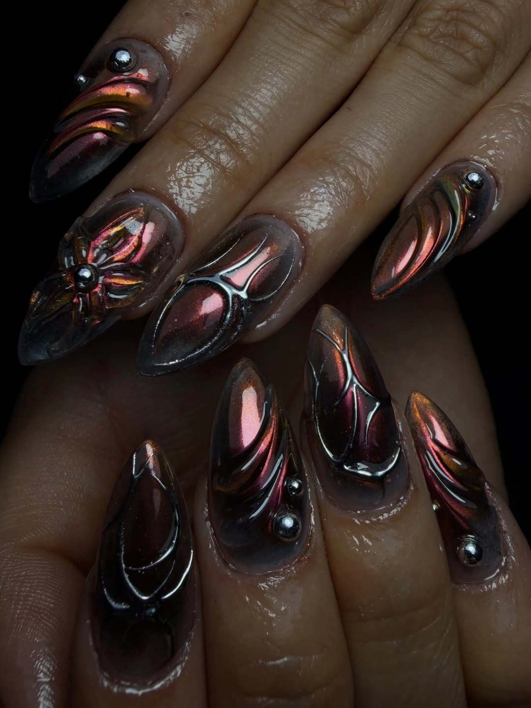 Long pointed near black nails with purple chrome curves and studs