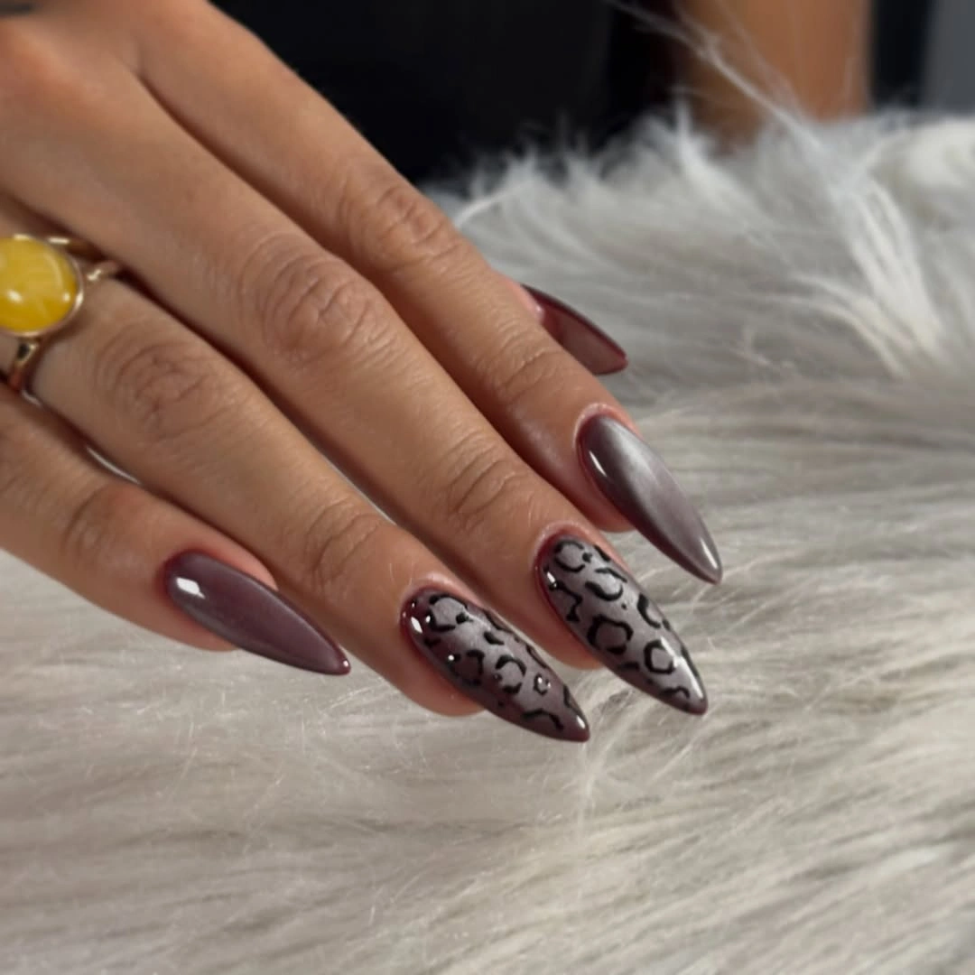 Medium mauve almond nails with subtle leopard print accents