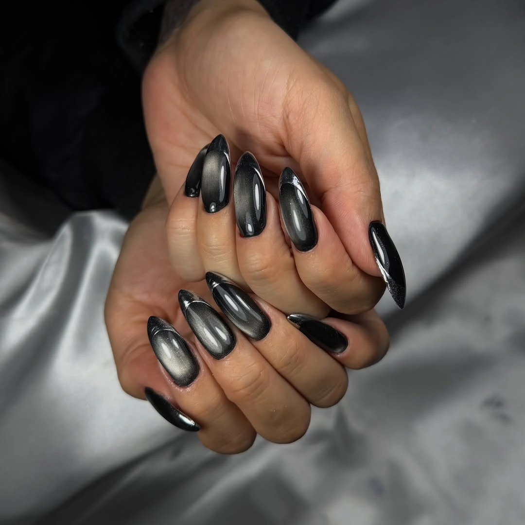Short rounded charcoal nails with narrow silver reflections