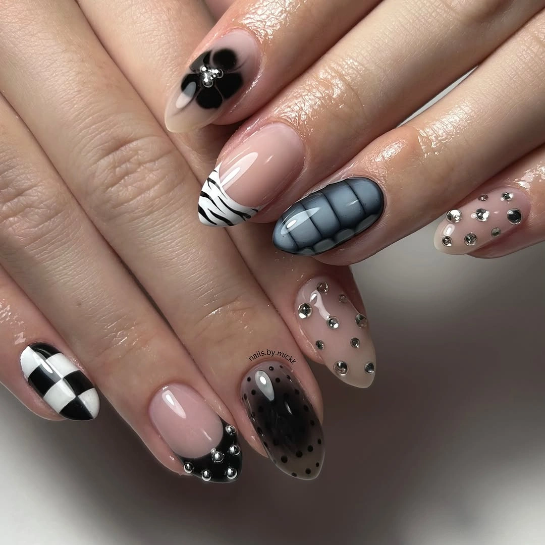 Mixed nude nails with checkerboard texture dots and metallic studs