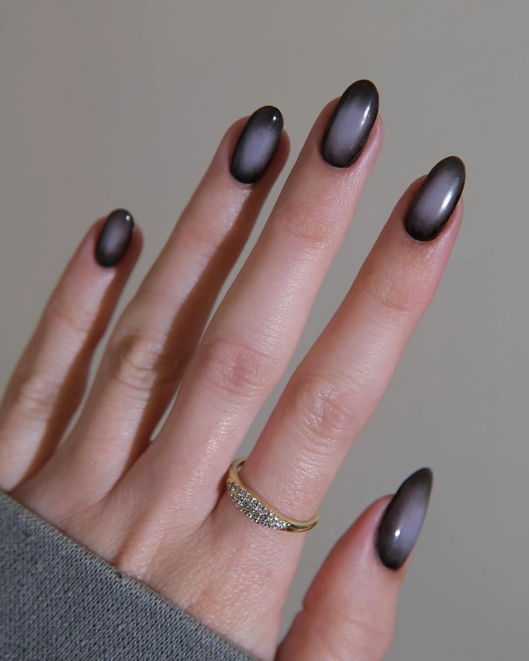 Short rounded nails with a smoky plum black glossy finish