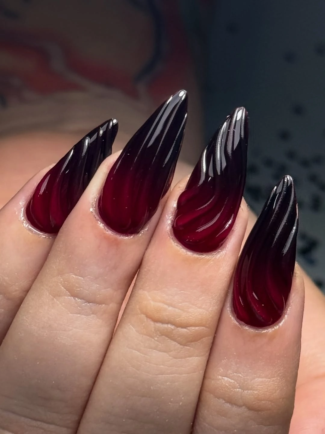 Long wine red nails with black edges and reflective ribbons
