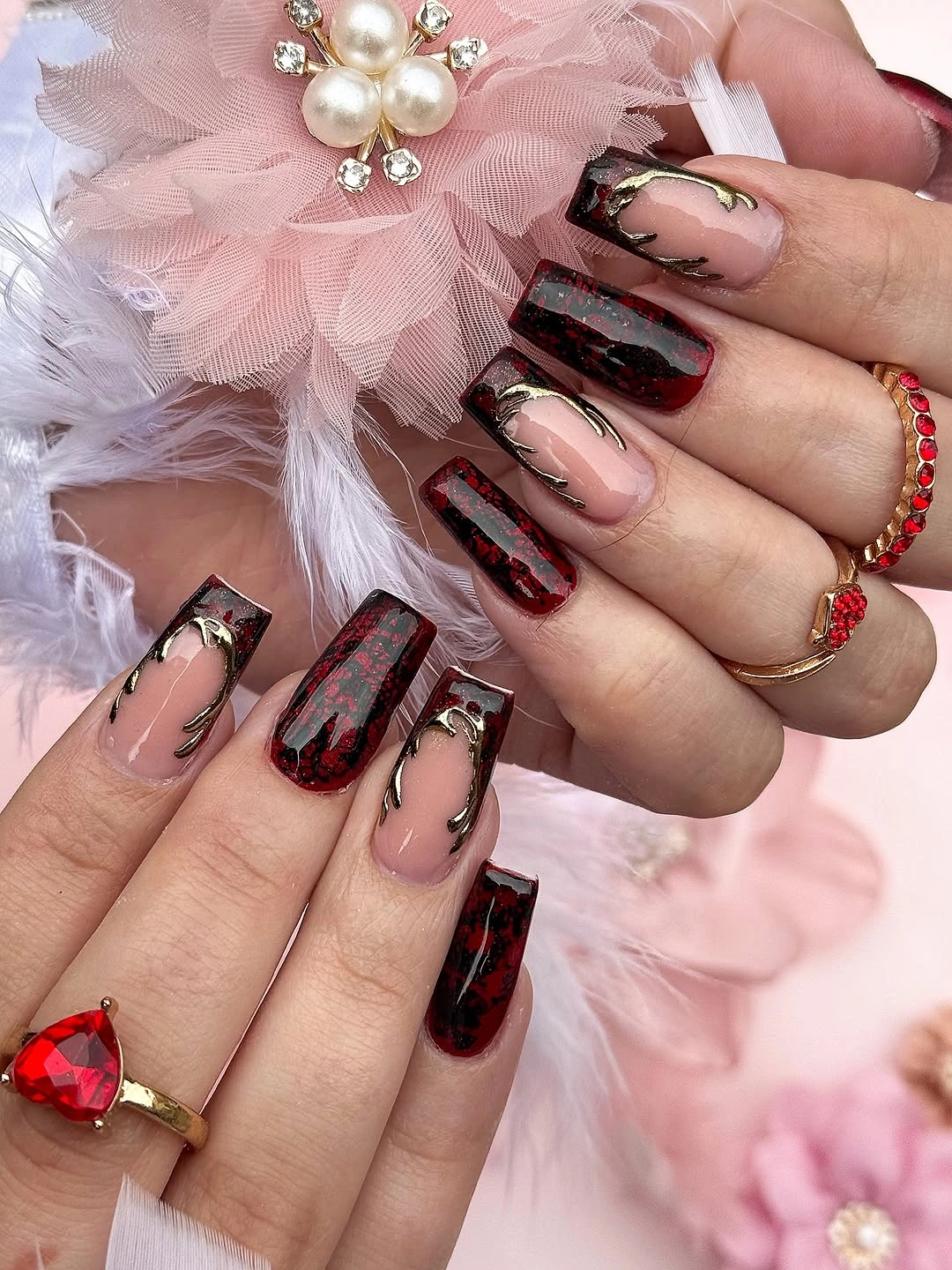 Long square nude nails with dark marbled panels and gold lines