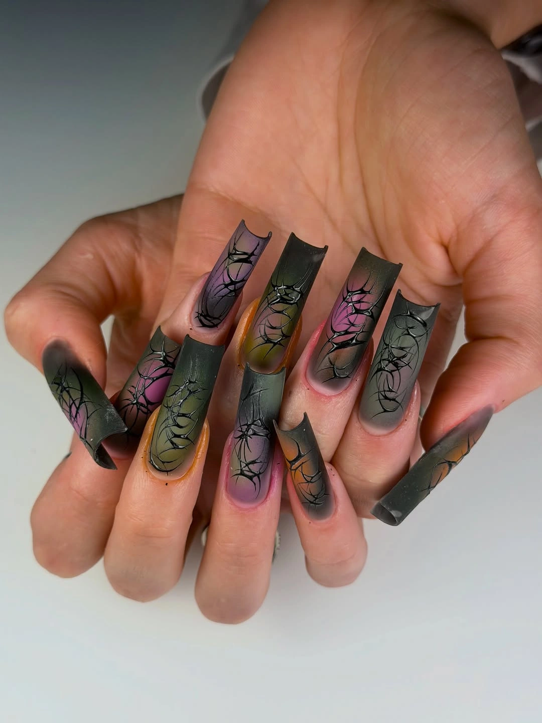Long square smoky olive nails with black floral web line work