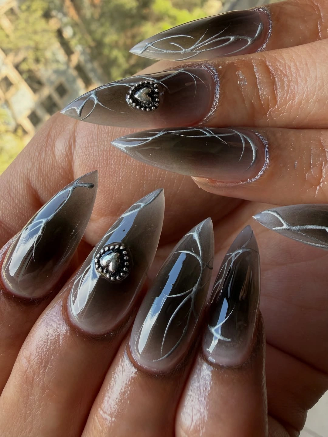 Long pointed smoky nails with clear edges and white curved lines