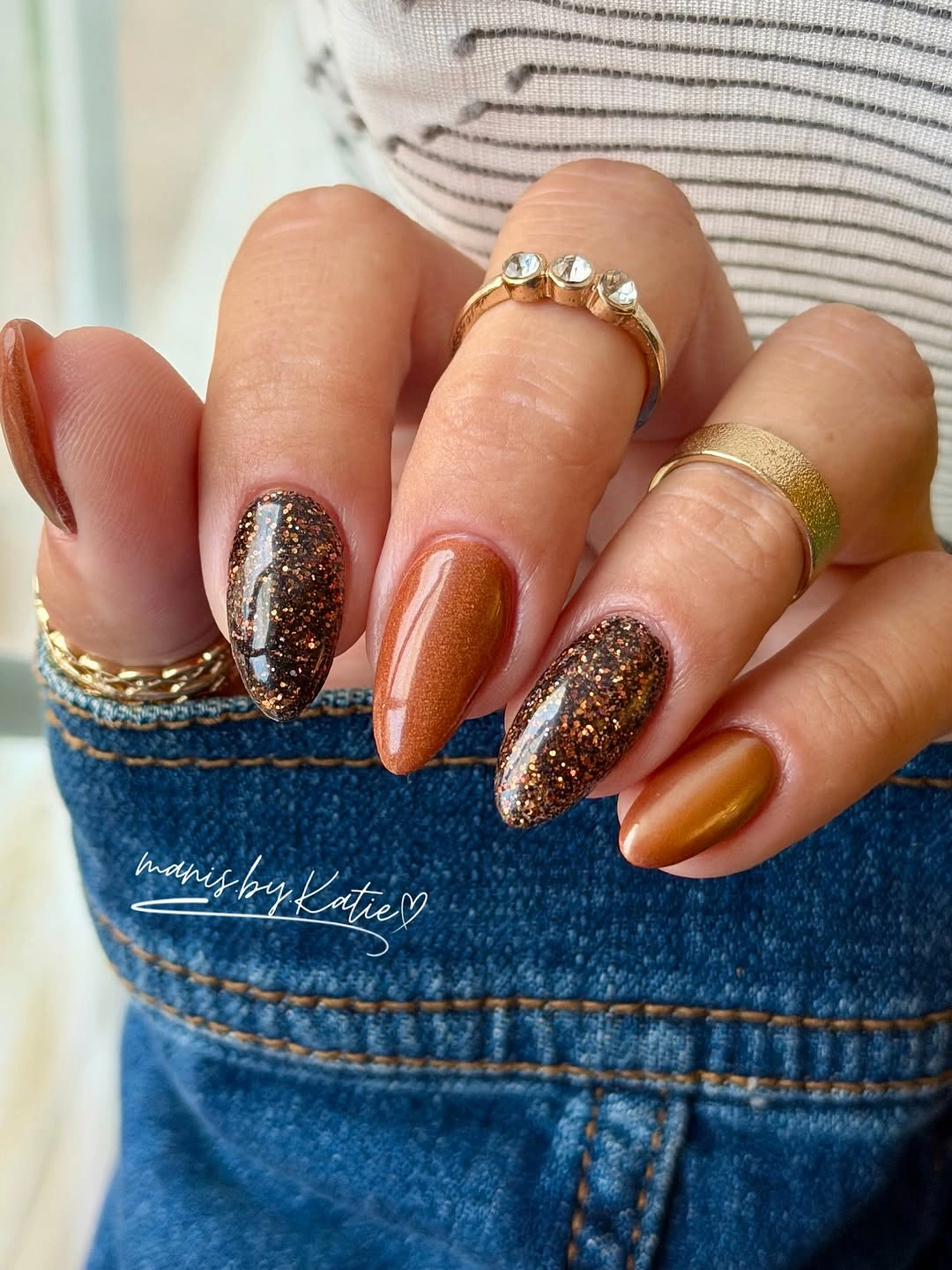 Caramel orange almond nails with dark brown glitter accents