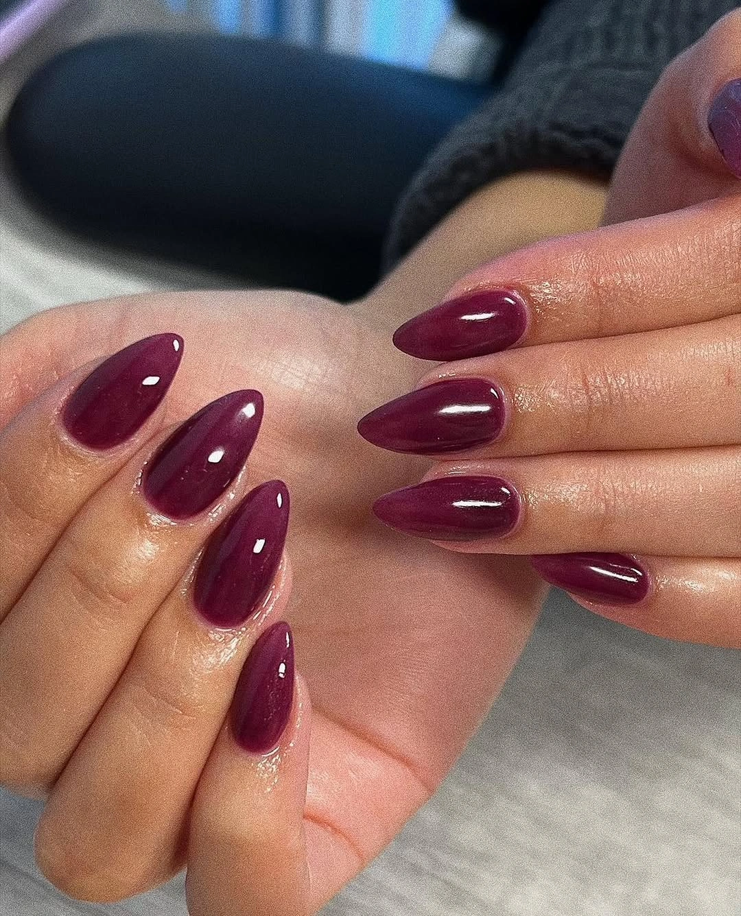 Medium almond nails in uniform deep burgundy color