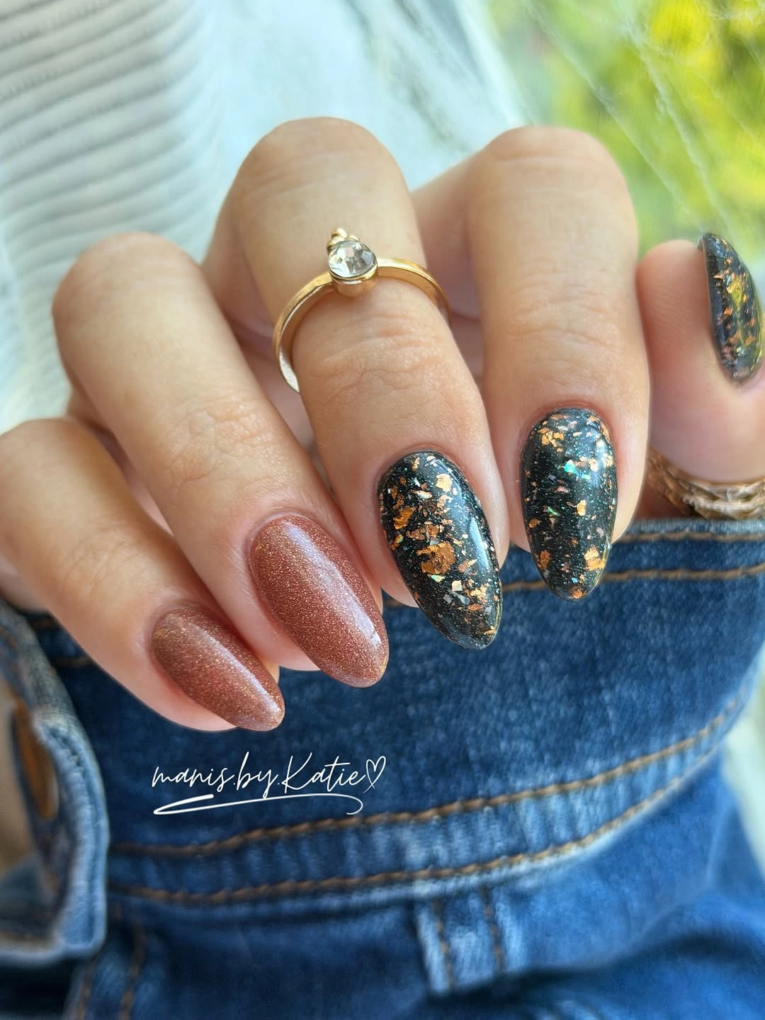 Nude almond nails with dark blue glitter accent nails