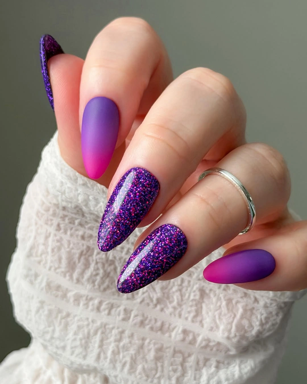 Long violet pink gradient nails with dark purple glitter accents