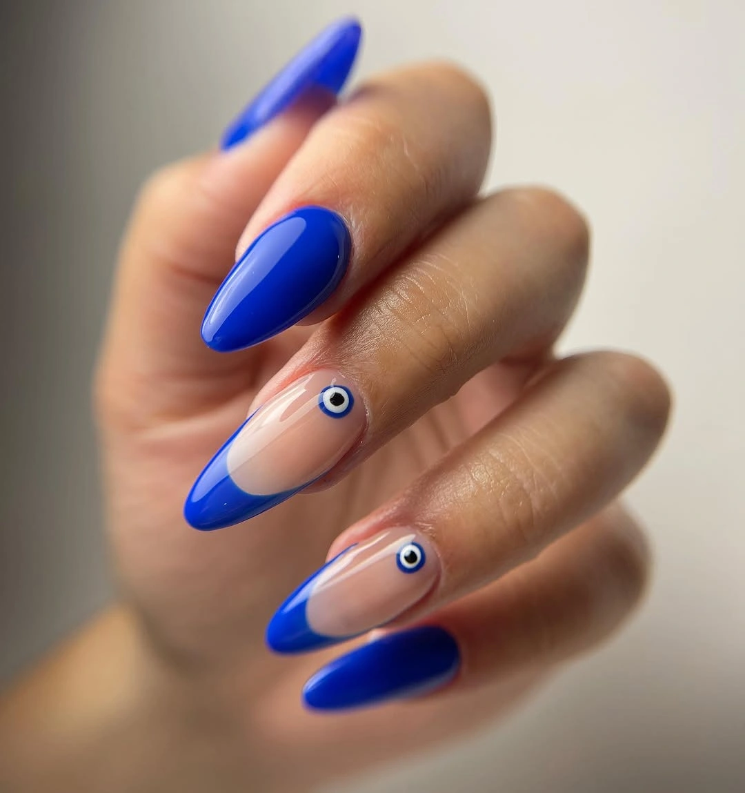 Long cobalt almond nails with translucent pink eye motifs