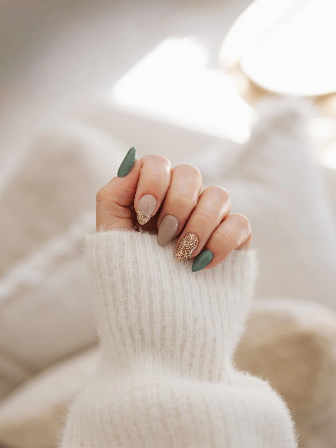 Short almond nails alternating muted sage green and nude