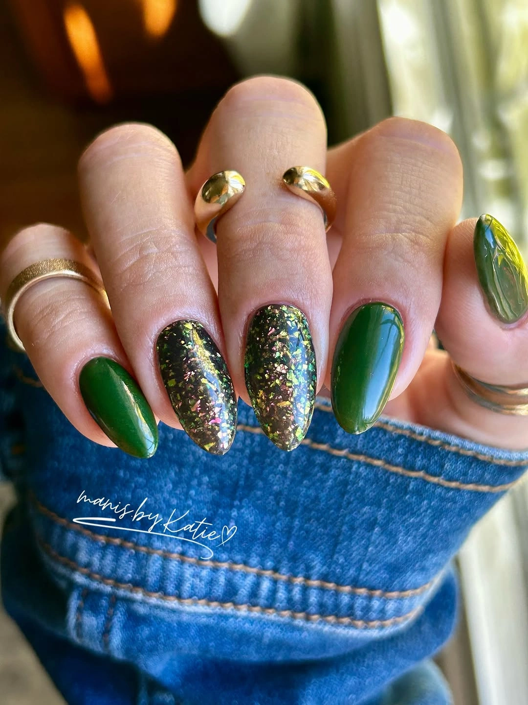 Long forest green almond nails with dark glitter accents