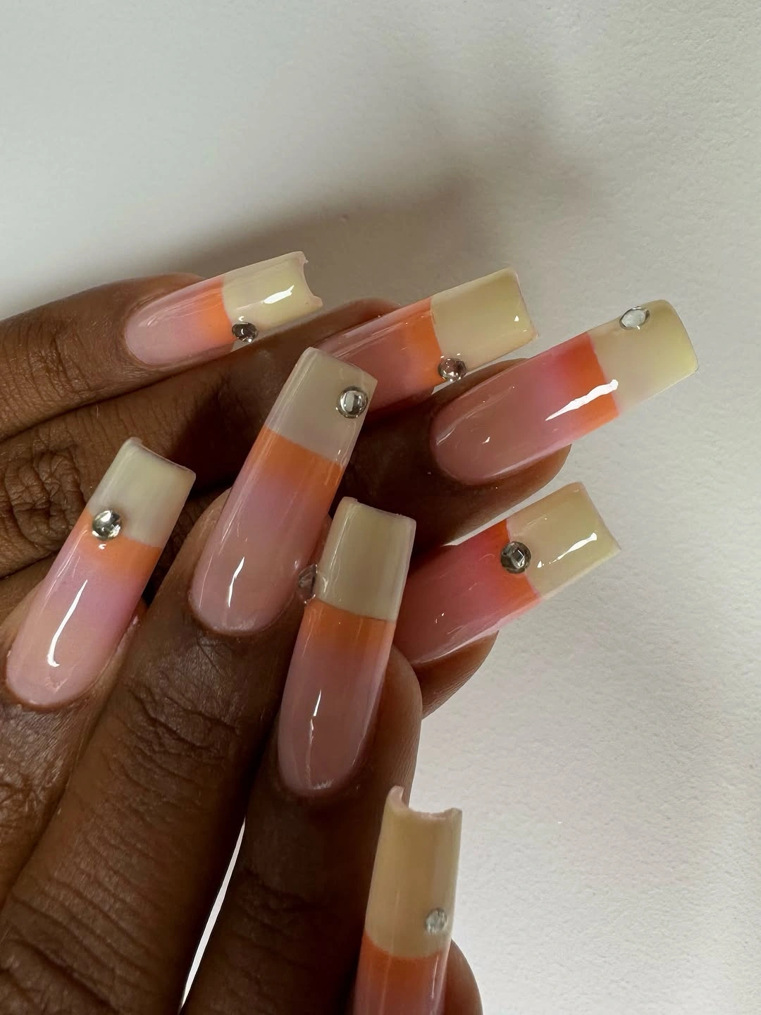 Long square nails with translucent amber cream and white tips