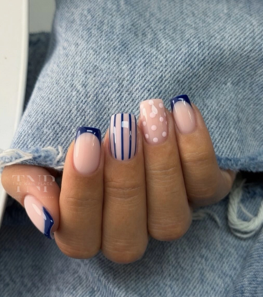 Pale squoval nails with navy tips stripes dots and checks