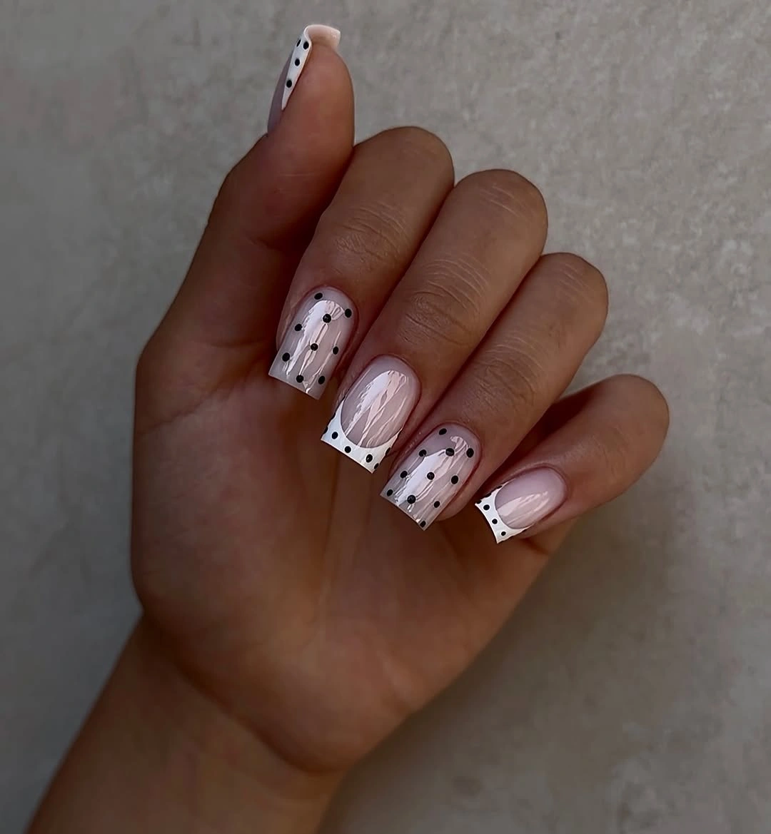 Pale pink square nails with white tips dots and black outlines