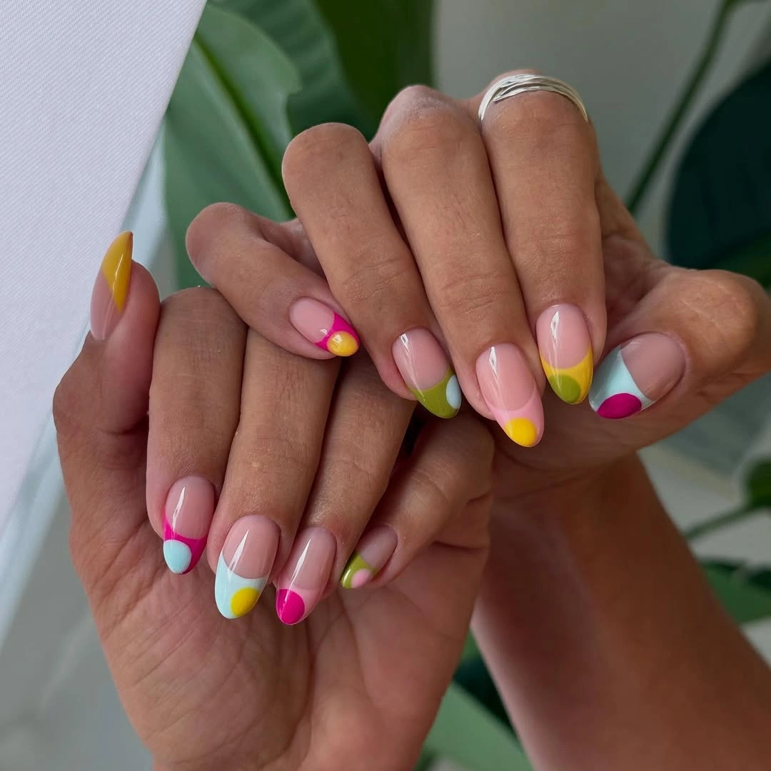 Rounded pink nails with hot pink yellow turquoise and white tips