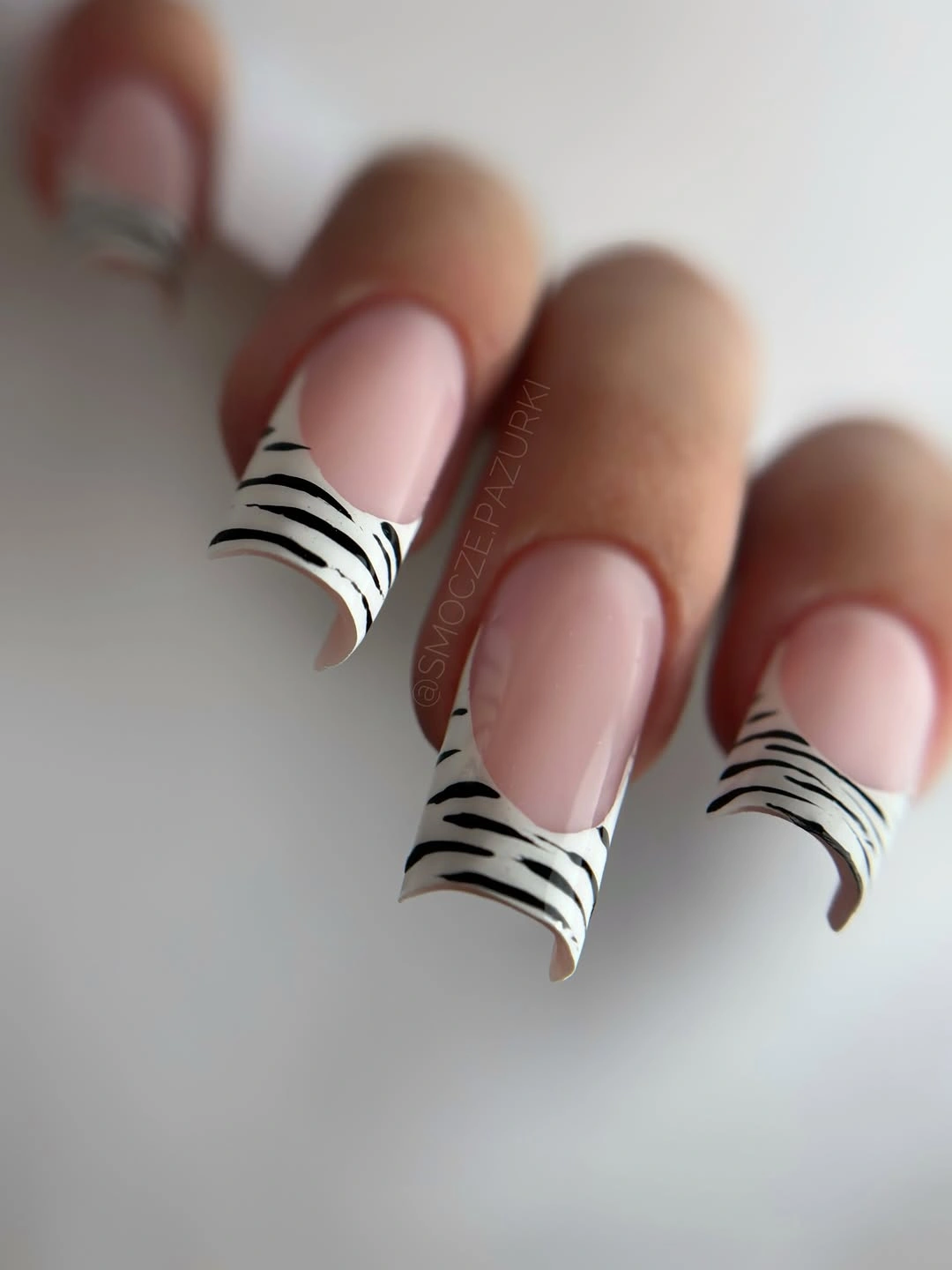 Sheer pink square nails with black and white zebra French tips