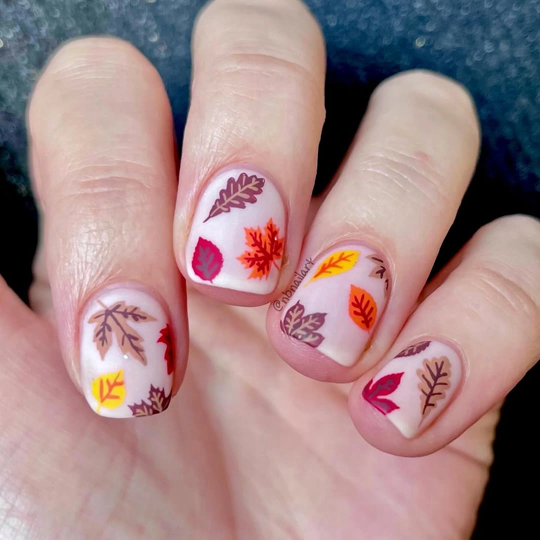 Short Pink Nails with Scattered Autumn Leaves