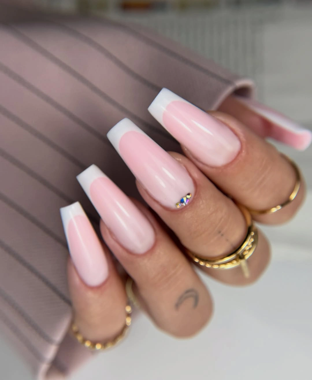 Pale pink long coffin nails with tiny bright rhinestone accents